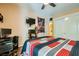 Comfortable bedroom featuring a TV, ceiling fan, closet, and a dedicated computer space at 5412 Harmony Green Dr # 101, Las Vegas, NV 89149