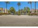 Community entrance with lush greenery and 'Villas' signage for a welcoming feel at 5412 Harmony Green Dr # 101, Las Vegas, NV 89149