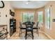 Bright dining area features a round table, seating for four, and a large window for natural light at 5412 Harmony Green Dr # 101, Las Vegas, NV 89149