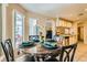 Bright dining area features a round table, seating for four, and stainless steel appliances at 5412 Harmony Green Dr # 101, Las Vegas, NV 89149