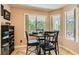 Bright dining area features a round table, seating for four, and a large window for natural light at 5412 Harmony Green Dr # 101, Las Vegas, NV 89149