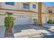 Townhome garage with desert landscaping and tiled roof at 5412 Harmony Green Dr # 101, Las Vegas, NV 89149