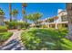 Beautiful condo complex with a lush green lawn, mature trees, and well-maintained landscaping at 5412 Harmony Green Dr # 101, Las Vegas, NV 89149