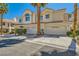 Two-story townhome with desert landscaping and a two-car garage in a sunny neighborhood at 5412 Harmony Green Dr # 101, Las Vegas, NV 89149