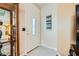 Inviting foyer with tiled flooring, glass display case, and a decorative front door at 5412 Harmony Green Dr # 101, Las Vegas, NV 89149