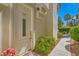 Inviting front door with decorative glass, enhanced by a well-maintained yard and walkway at 5412 Harmony Green Dr # 101, Las Vegas, NV 89149