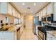Bright kitchen with granite countertops and stainless appliances provides ample space and style at 5412 Harmony Green Dr # 101, Las Vegas, NV 89149