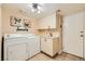 Well-equipped laundry room with a washer, dryer, sink, and ample storage at 5412 Harmony Green Dr # 101, Las Vegas, NV 89149