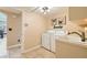 Functional laundry room with a washer, dryer, sink, and tile flooring at 5412 Harmony Green Dr # 101, Las Vegas, NV 89149