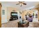 Comfortable living room boasts a cozy feel with plush carpet and access to the kitchen at 5412 Harmony Green Dr # 101, Las Vegas, NV 89149