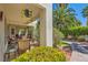 Relaxing covered patio area with comfortable seating, lush greenery, and shade at 5412 Harmony Green Dr # 101, Las Vegas, NV 89149