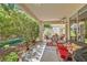 Relaxing covered patio space with outdoor furniture and shade from mature trees at 5412 Harmony Green Dr # 101, Las Vegas, NV 89149