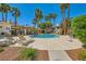 Community pool with lounge chairs and a waterfall feature, surrounded by lush landscaping at 5412 Harmony Green Dr # 101, Las Vegas, NV 89149