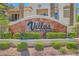 'Villas on the Green' signage amidst manicured landscaping, enhancing community appeal at 5412 Harmony Green Dr # 101, Las Vegas, NV 89149