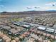 Expansive aerial view showcasing a neighborhood in Las Vegas with mountain views at 6790 Gold Yarrow St, Las Vegas, NV 89148