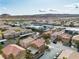 Aerial image displaying colorful homes in a neighborhood, plus nearby stores and mountains off in the distance at 6790 Gold Yarrow St, Las Vegas, NV 89148