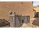 Two York air conditioning units sit in a gravel-filled side yard next to the home's stucco wall at 6790 Gold Yarrow St, Las Vegas, NV 89148