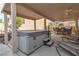 Enjoy outdoor living with this backyard's covered patio featuring a spa, bar seating, and lounge furniture at 6790 Gold Yarrow St, Las Vegas, NV 89148