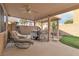 Backyard featuring a covered patio, hot tub, and artificial turf for low-maintenance outdoor living at 6790 Gold Yarrow St, Las Vegas, NV 89148