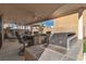 Back patio with stainless steel grill, bar seating, an artificial putting green, and a covered ceiling at 6790 Gold Yarrow St, Las Vegas, NV 89148