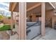 Relaxing backyard oasis featuring a hot tub, covered patio, artificial turf and a serene, private setting at 6790 Gold Yarrow St, Las Vegas, NV 89148