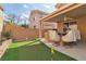 Outdoor patio area showcasing the artificial turf putting green, grill, and bar with seating at 6790 Gold Yarrow St, Las Vegas, NV 89148