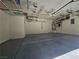 This garage has epoxy flooring and overhead storage racks for organized space at 6790 Gold Yarrow St, Las Vegas, NV 89148