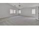 Spacious main bedroom features vaulted ceilings, a ceiling fan, neutral carpeting, and bright, natural light at 6790 Gold Yarrow St, Las Vegas, NV 89148