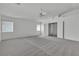 Bright main bedroom boasts neutral carpeting, a ceiling fan, and an attached sitting room or closet at 6790 Gold Yarrow St, Las Vegas, NV 89148