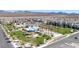 This aerial view highlights the pool, playground, and landscaping of this Gathering-friendly community at 6804 Surf Green Ct, North Las Vegas, NV 89086