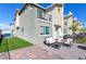 Cozy back patio with outdoor seating and manicured artificial turf, perfect for relaxing or entertaining at 6804 Surf Green Ct, North Las Vegas, NV 89086