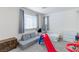 Bedroom with play area and gray sofa at 6804 Surf Green Ct, North Las Vegas, NV 89086
