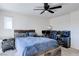 This bedroom has a ceiling fan and space for both a bed and a home office at 6804 Surf Green Ct, North Las Vegas, NV 89086