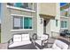 Welcoming front patio with cozy seating arrangement, ideal for relaxing outdoors at 6804 Surf Green Ct, North Las Vegas, NV 89086