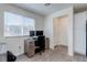 Bright home office with natural light, featuring a work desk and ample storage space at 6804 Surf Green Ct, North Las Vegas, NV 89086