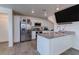 Modern kitchen featuring stainless steel appliances, granite countertops, and ample storage space at 6804 Surf Green Ct, North Las Vegas, NV 89086