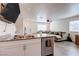 Open-concept living space with modern finishes and a large sectional sofa at 6804 Surf Green Ct, North Las Vegas, NV 89086