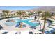 Stunning community pool with palm trees and lounge chairs, perfect for relaxation and recreation at 6804 Surf Green Ct, North Las Vegas, NV 89086