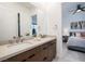 Modern bathroom features a double sink vanity, large mirror, and a view into the bedroom at 794 Willits St, Las Vegas, NV 89138