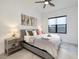 Bright bedroom features a gray upholstered bed, modern art, and a ceiling fan at 794 Willits St, Las Vegas, NV 89138