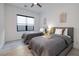 Bright bedroom boasts two beds, modern art, and a ceiling fan at 794 Willits St, Las Vegas, NV 89138