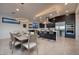 Open-concept layout featuring a modern dining area connected to the kitchen with an island and bar stool seating at 794 Willits St, Las Vegas, NV 89138