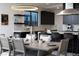 Open-concept dining area connected to a modern kitchen featuring stylish lighting and sophisticated decor at 794 Willits St, Las Vegas, NV 89138