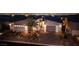 Modern home exterior at night with a well-lit driveway and desert landscaping at 794 Willits St, Las Vegas, NV 89138