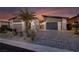 Contemporary home's exterior showcasing a paved driveway, desert landscaping, and a modern facade at 794 Willits St, Las Vegas, NV 89138