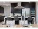 Beautiful kitchen island and dining area featuring dark cabinets, granite counters, and stainless steel appliances at 794 Willits St, Las Vegas, NV 89138