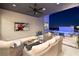 Inviting covered patio with plush seating, a ceiling fan, a TV, and views of the pool and city lights at 794 Willits St, Las Vegas, NV 89138