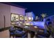 Outdoor patio with dining table, seating, modern architecture, and a pool glowing at dusk at 794 Willits St, Las Vegas, NV 89138