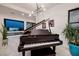 Charming piano room featuring a grand piano, sleek lighting, and a view of the outdoors at 794 Willits St, Las Vegas, NV 89138