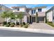 Well-manicured two-story home with a three car garage, desert landscaping and a brick driveway at 8245 Broad Branch Way, Las Vegas, NV 89113